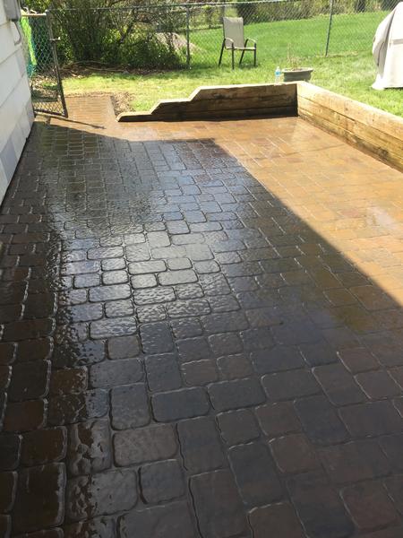 professionally installed dark colored cobblestone paver patio